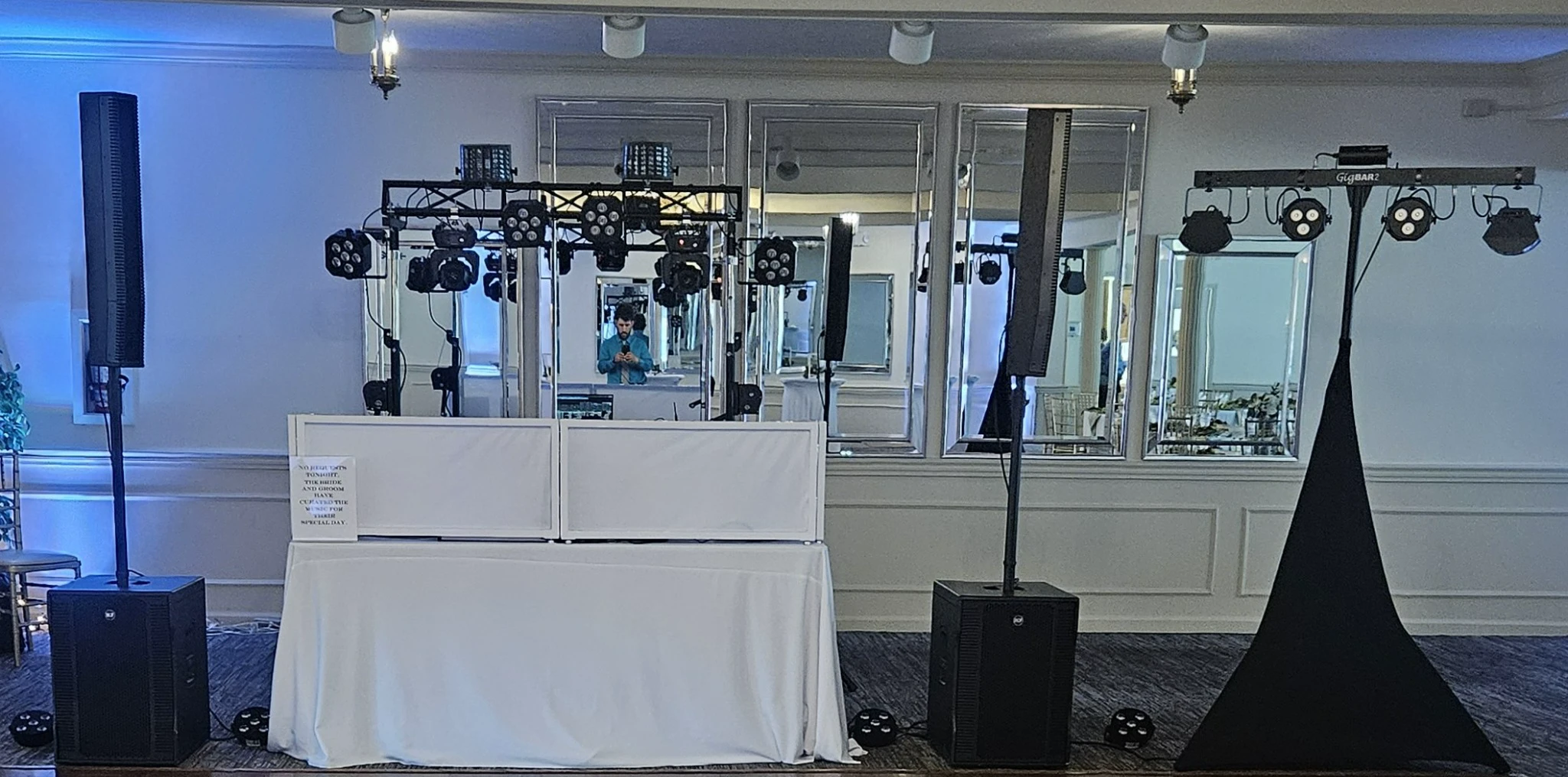 PJE Entertainment DJ setup with line array speakers and blue uplighting