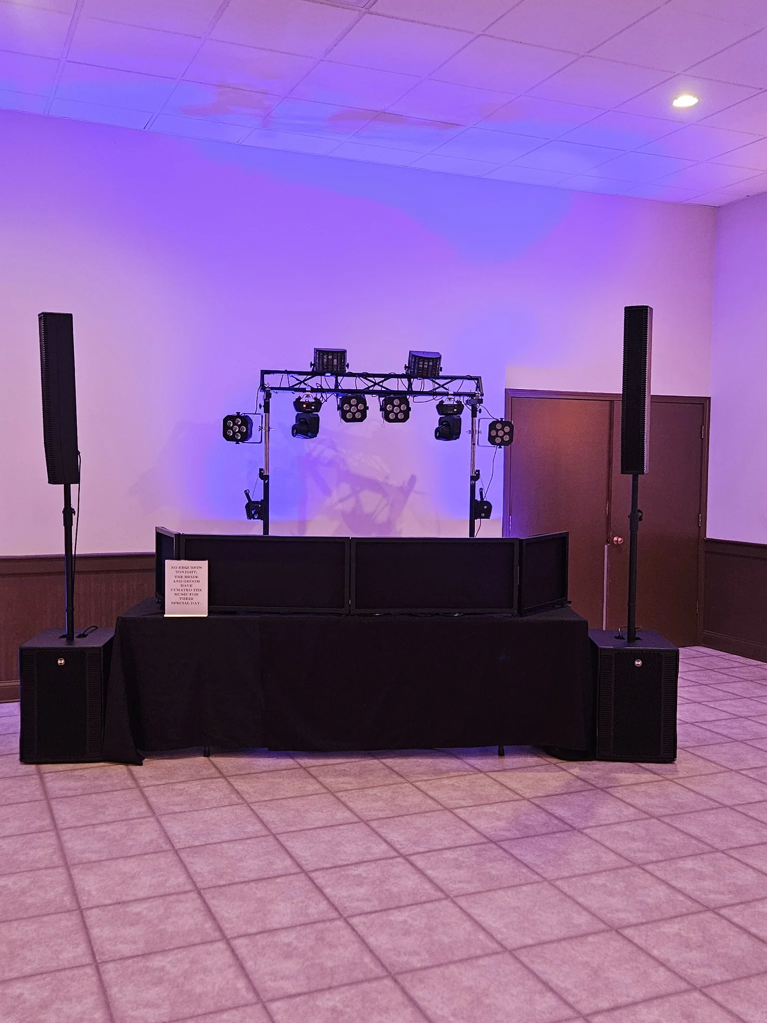 DJ setup with purple uplighting